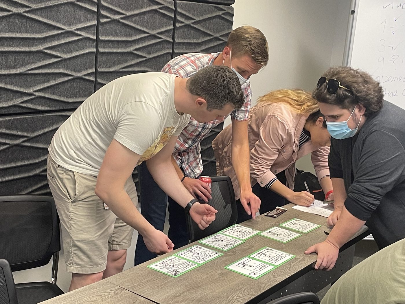 Teammates solving picture panels around a table