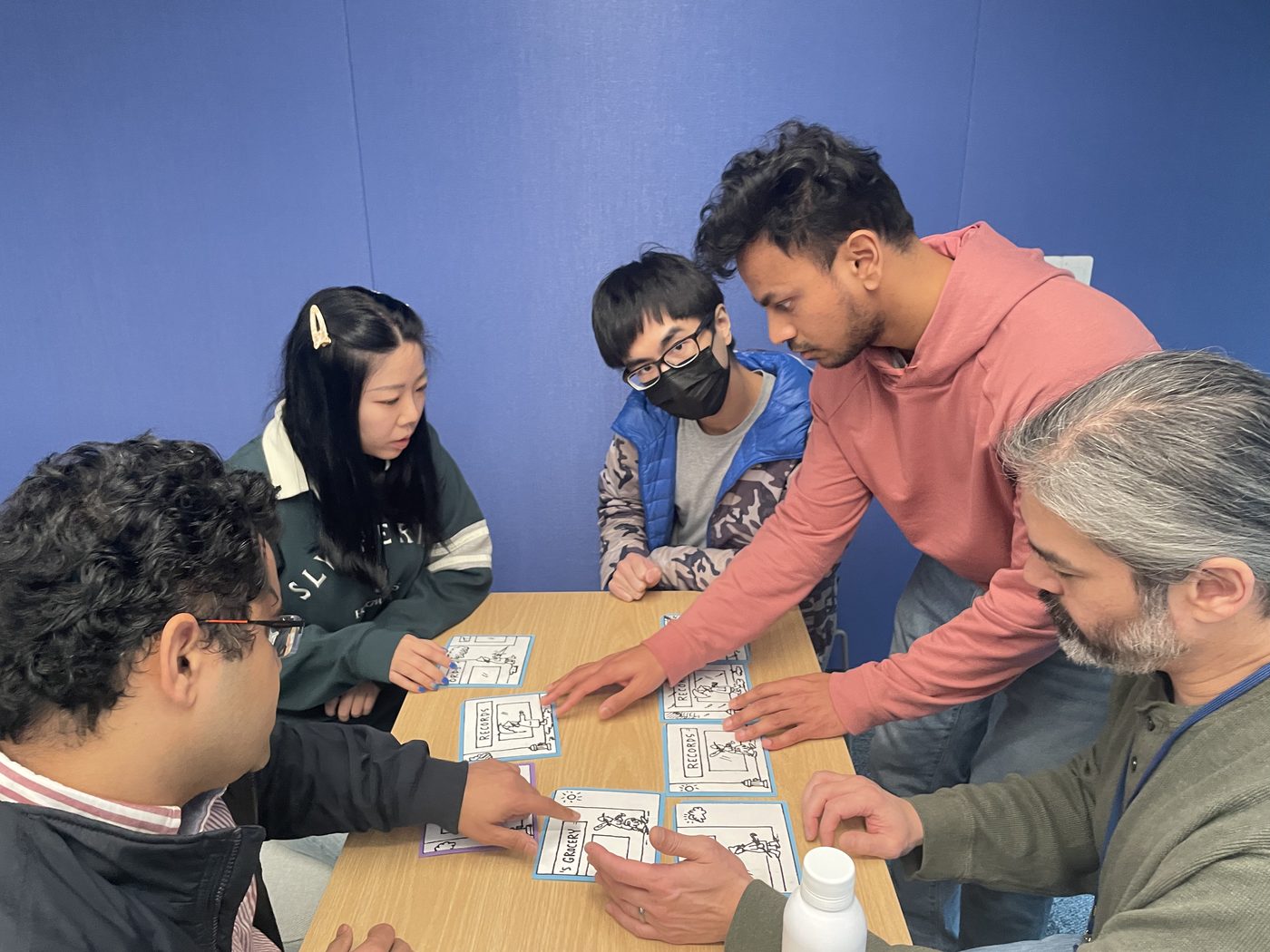 A team arranging picture panels at a challenge table
