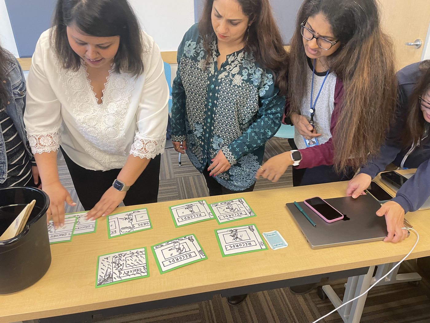 Teammates working together to put story cards in order