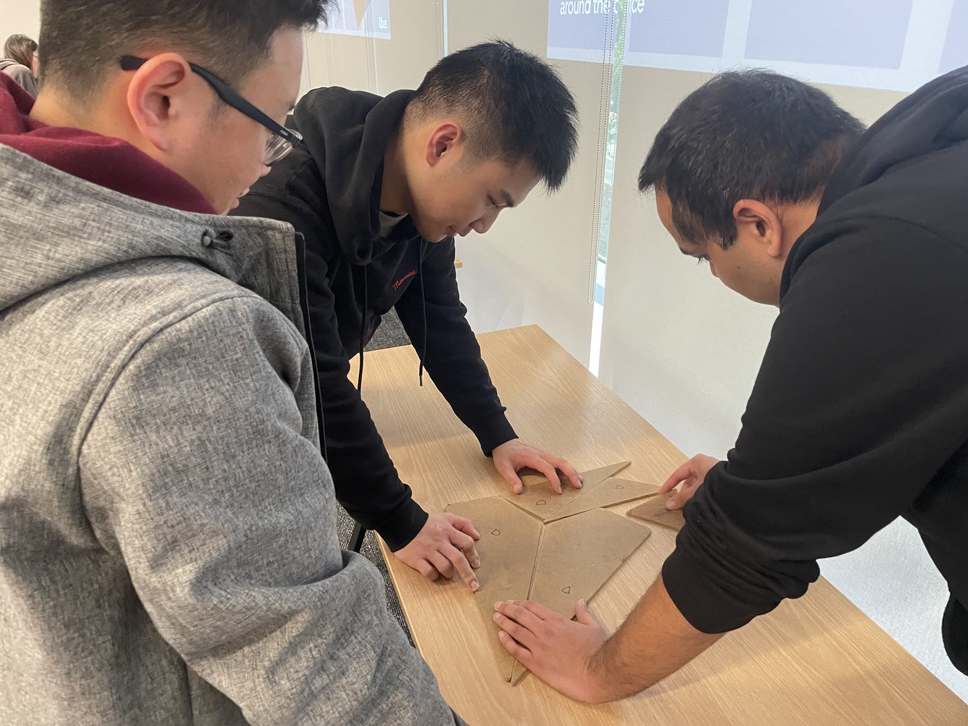 Participants concentrating on a small tabletop challenge
