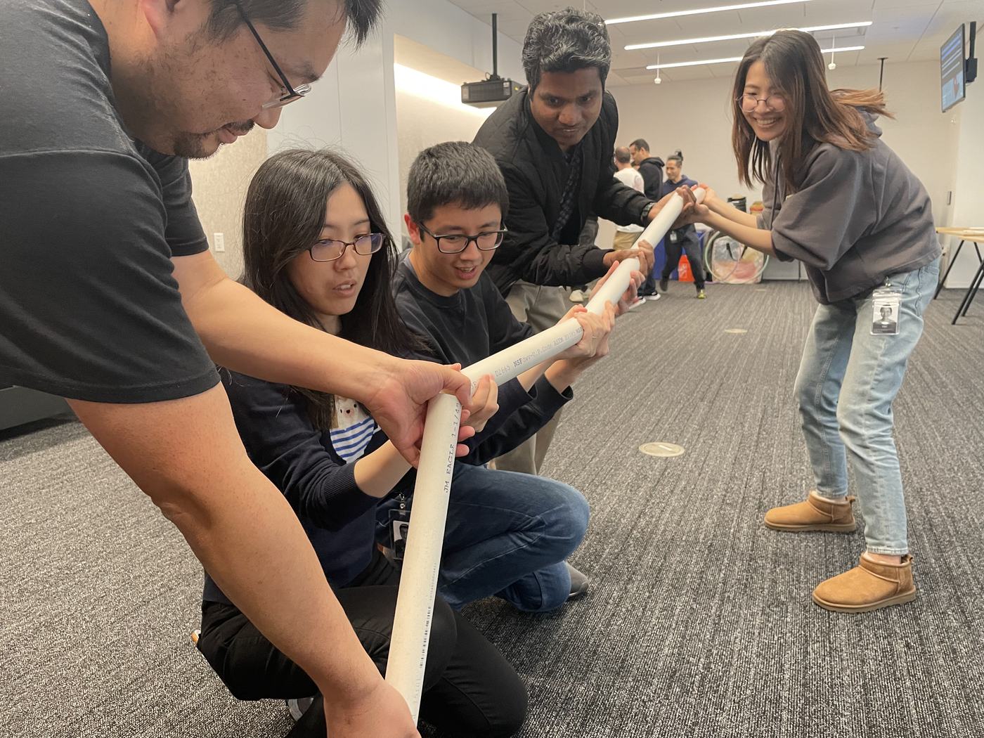 A team coordinating a marble pipeline challenge