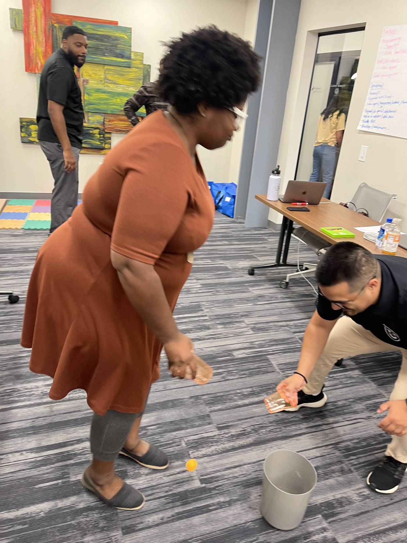Participants practicing a challenge around a table