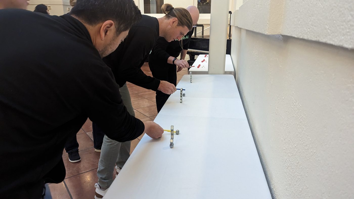 Participants concentrating on a cup challenge